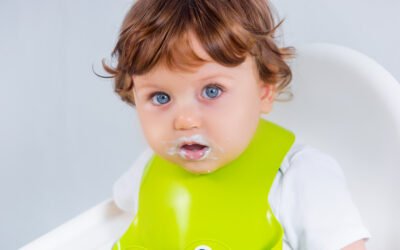 baby spitting up clear liquid hours after eating