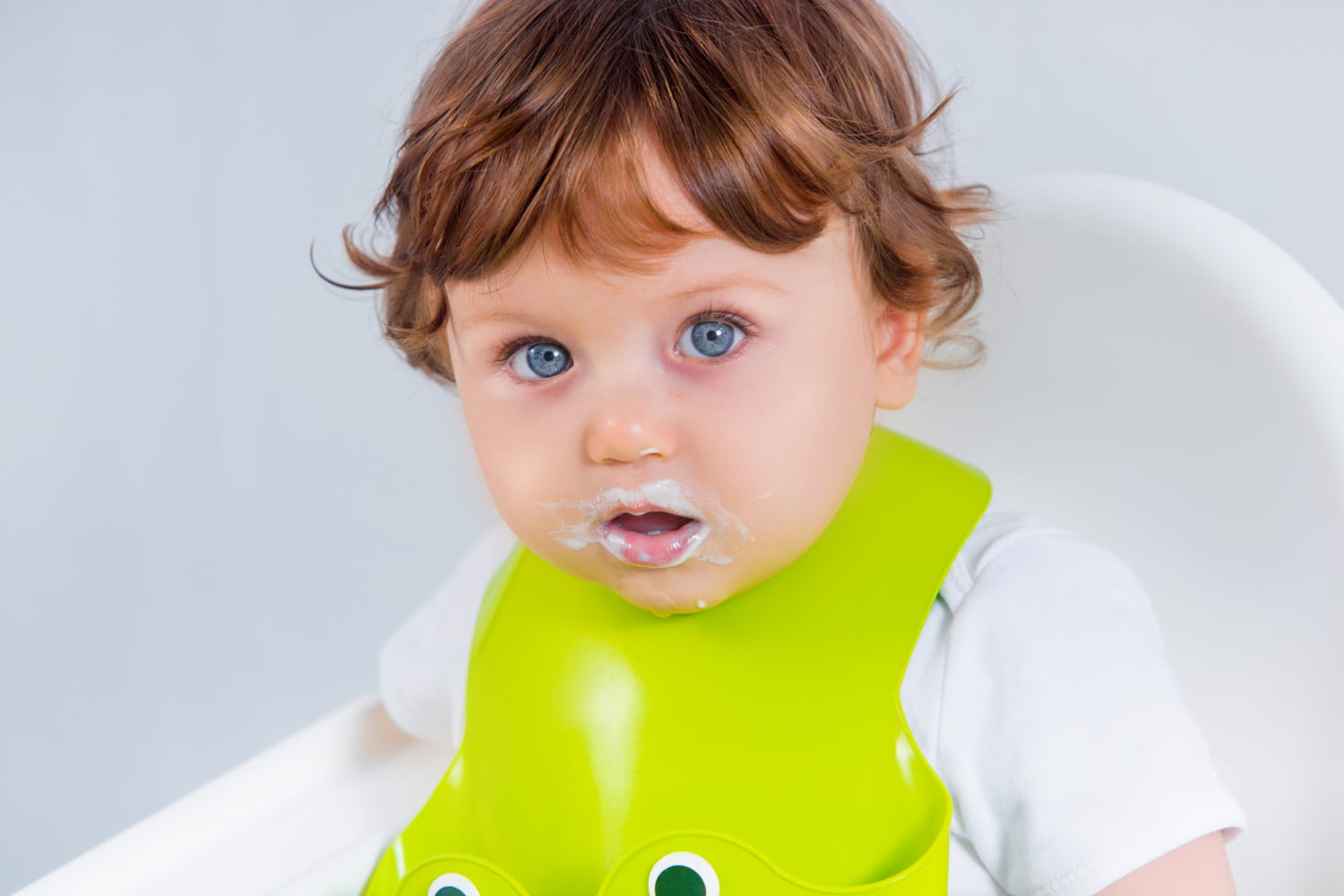 baby spitting up clear liquid hours after eating